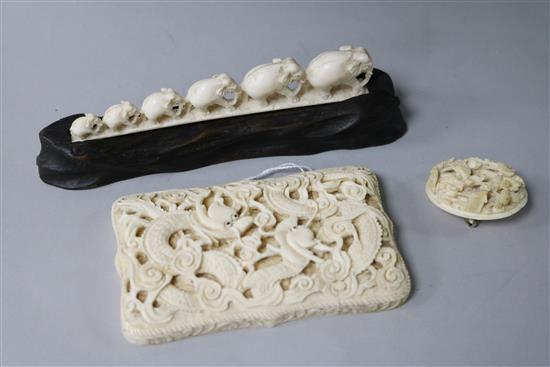 An early 20th century Chinese ivory card case, brooch and an elephant group